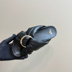 Fendi ladies’ black leather slide sandal close-up, gold-tone chain on strap