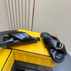 Fendi ladies’ black leather slide sandals, side view with twisted knot strap and logo