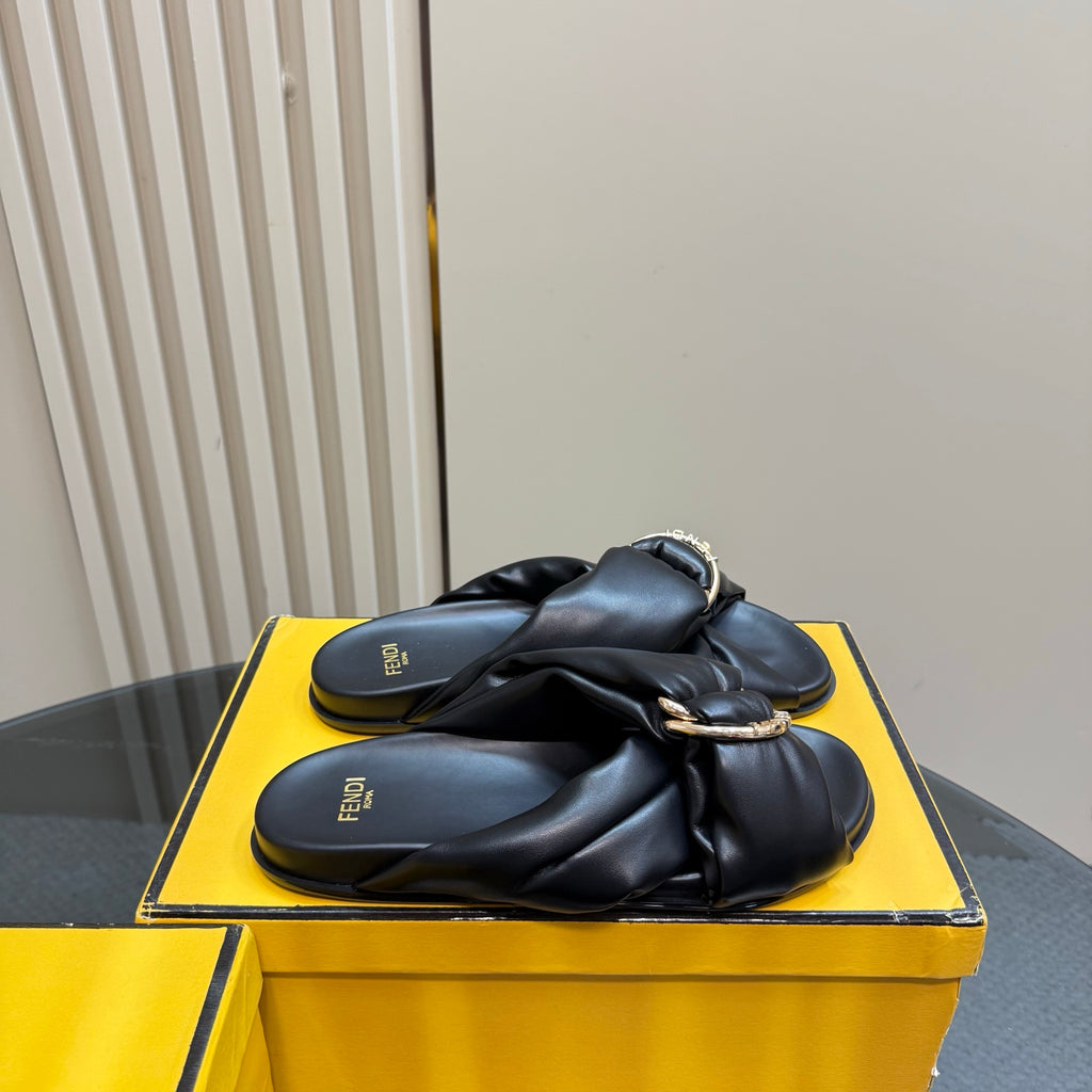 Fendi ladies’ black leather slide sandals, side view with gold-tone chain detail