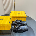 Fendi ladies’ black leather slide sandals, twisted knot strap with gold chain detail