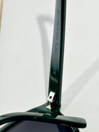 Bottega Veneta glasses with dark green temple and brand text detail