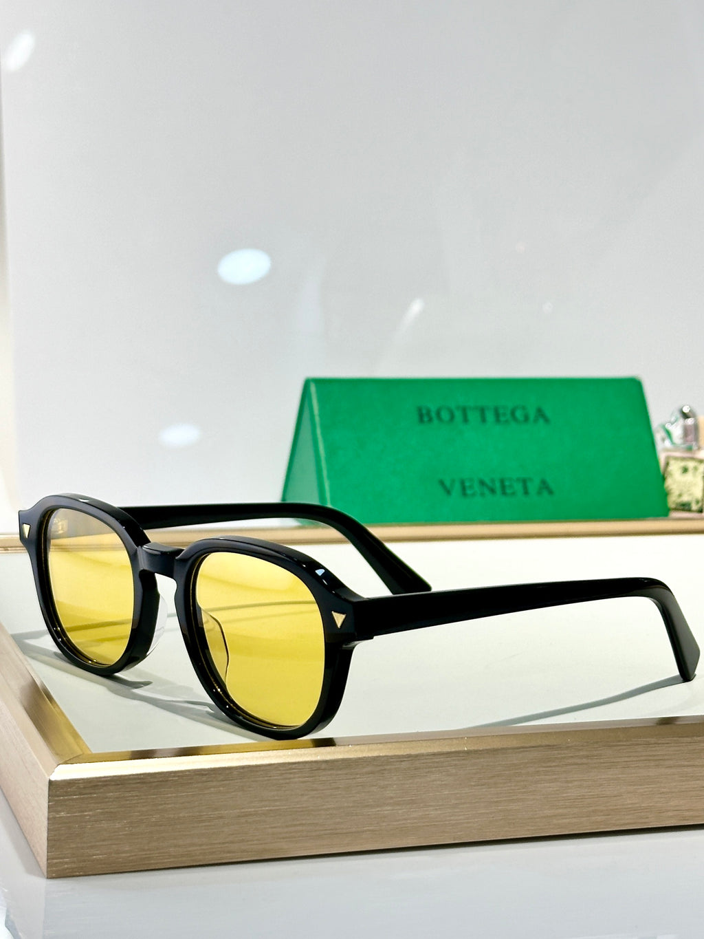 Bottega Veneta glasses with black frame and yellow tinted lenses