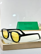 Bottega Veneta glasses with black frame and yellow tinted lenses
