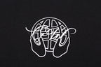 Black crew-neck T-shirt with white outline globe-and-hands emblem on chest