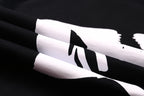 Black T-shirt close-up of sleeve/side graphic in white print