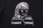 Black T-shirt close-up of line-art portrait graphic with braids