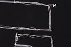Black T-shirt back graphic close-up: outlined rectangles and lines with TM mark