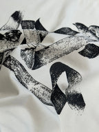 White T-shirt fabric with bold black bird pattern