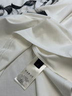 White T-shirt with hang tag and care label visible on the fabric
