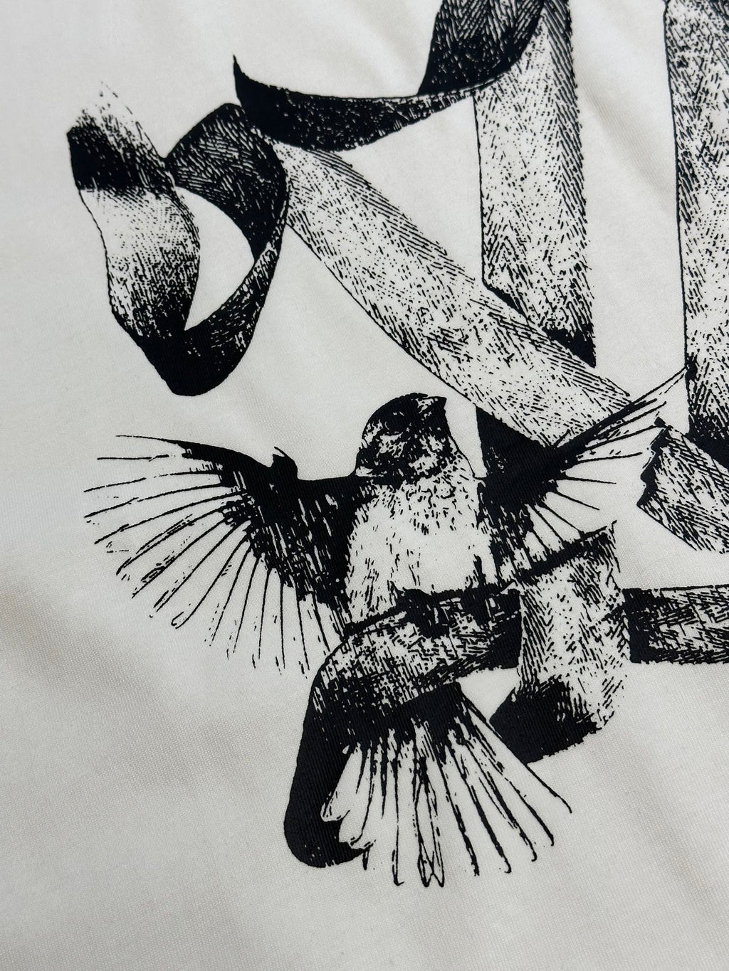 White T-shirt featuring a close-up black bird graphic