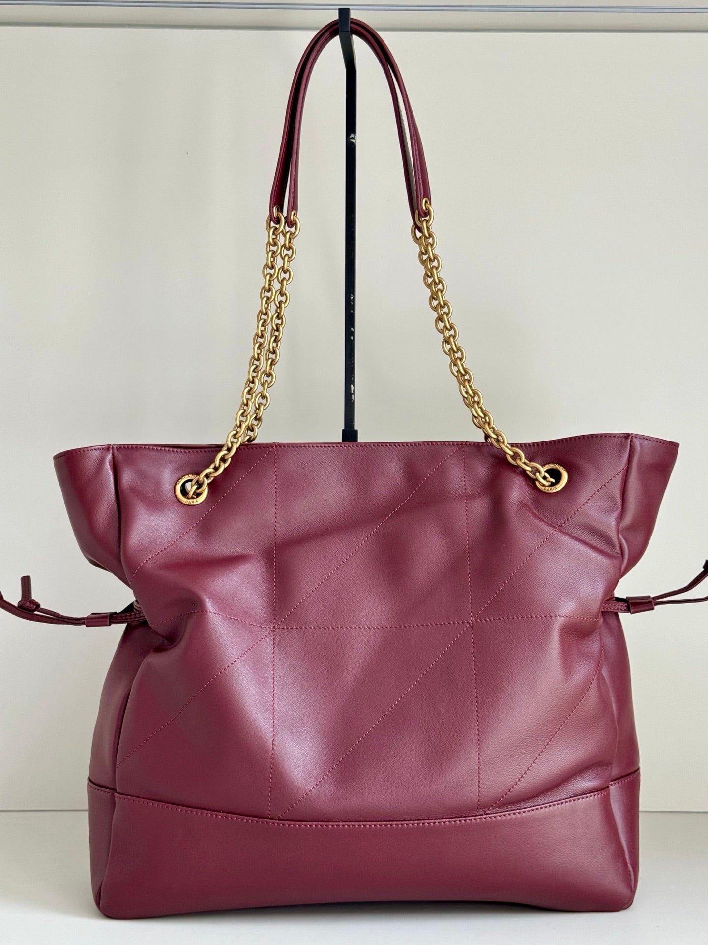 YSL quilted tote bag with burgundy leather, gold chain handles, and side pouch detail