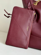 YSL leather crossbody pouch in burgundy with gold zipper pull and diagonal stitching