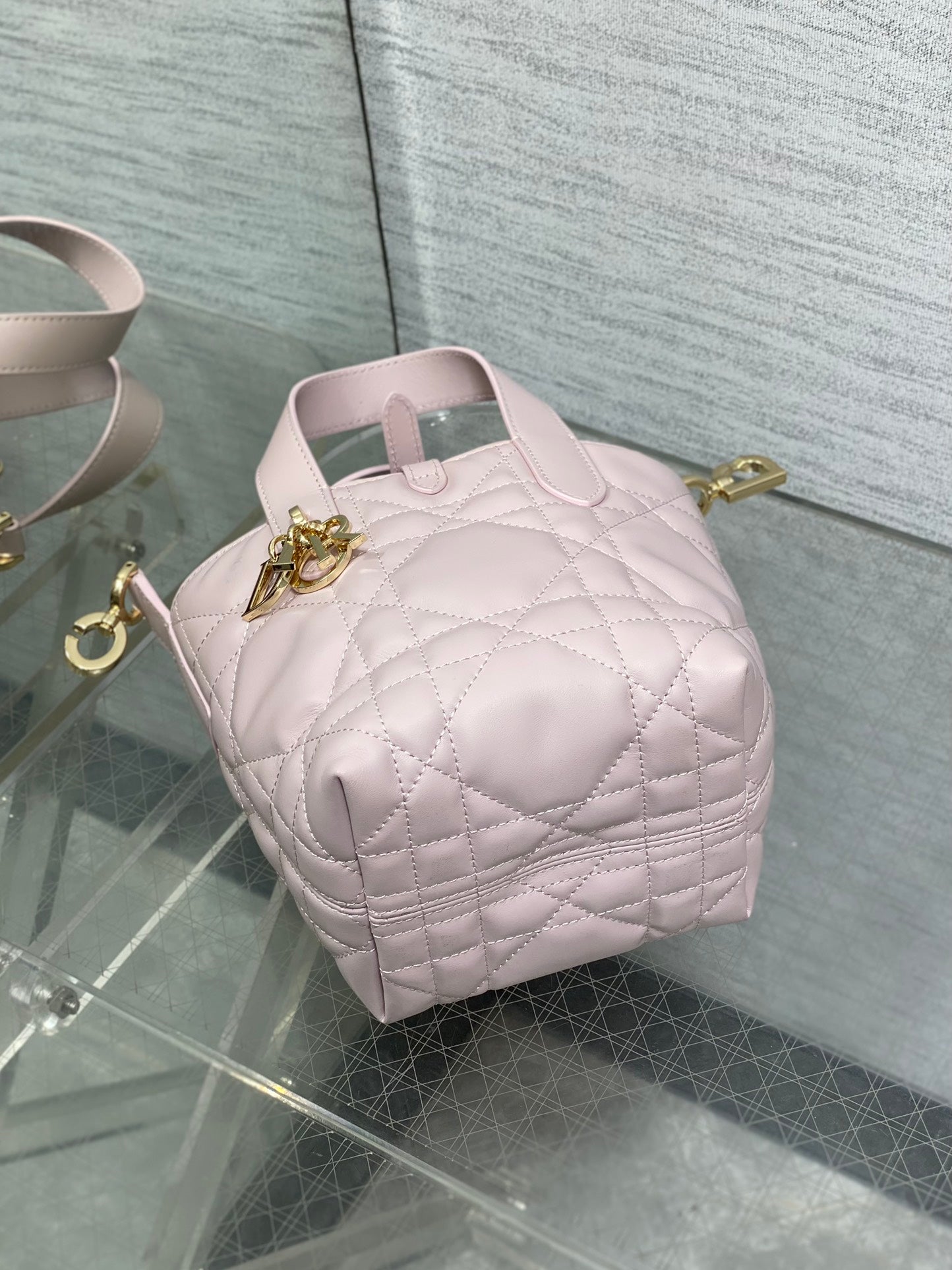 Pink Dior quilted mini handbag with gold hardware and top handle view