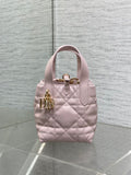 Pink quilted Dior handbag with top handle and gold front clasp