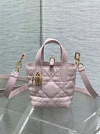 Pink Dior handbag with shoulder straps, quilted pattern, and gold hardware