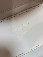 Dior logo and "Made in Italy" print on light pink handbag interior lining