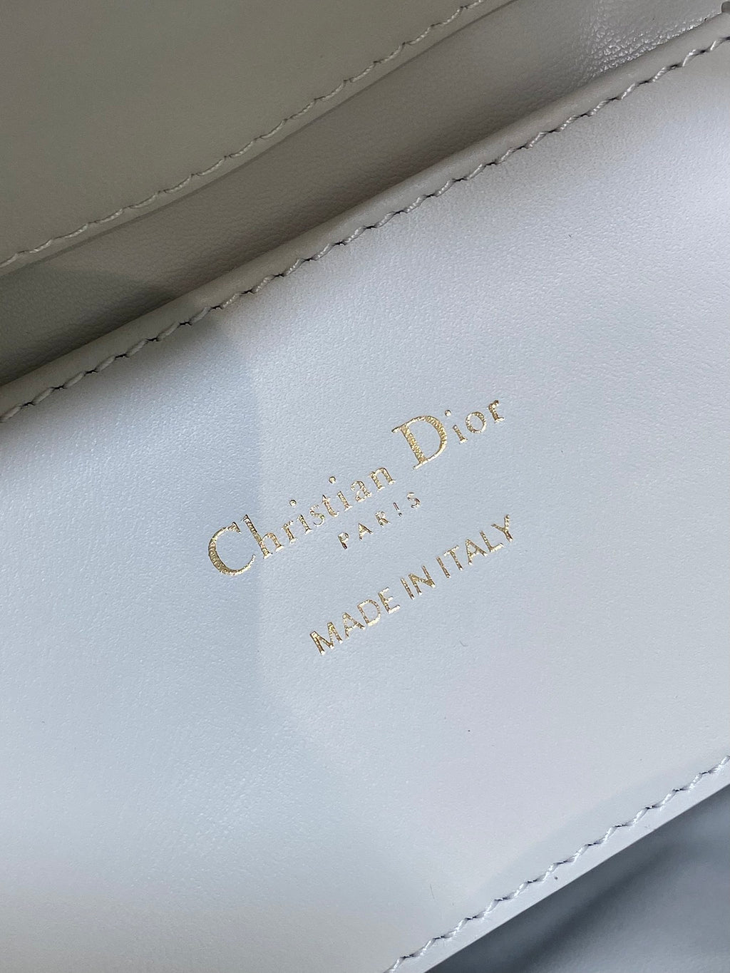 Dior 'MADE IN ITALY' logo on white leather quilted bag