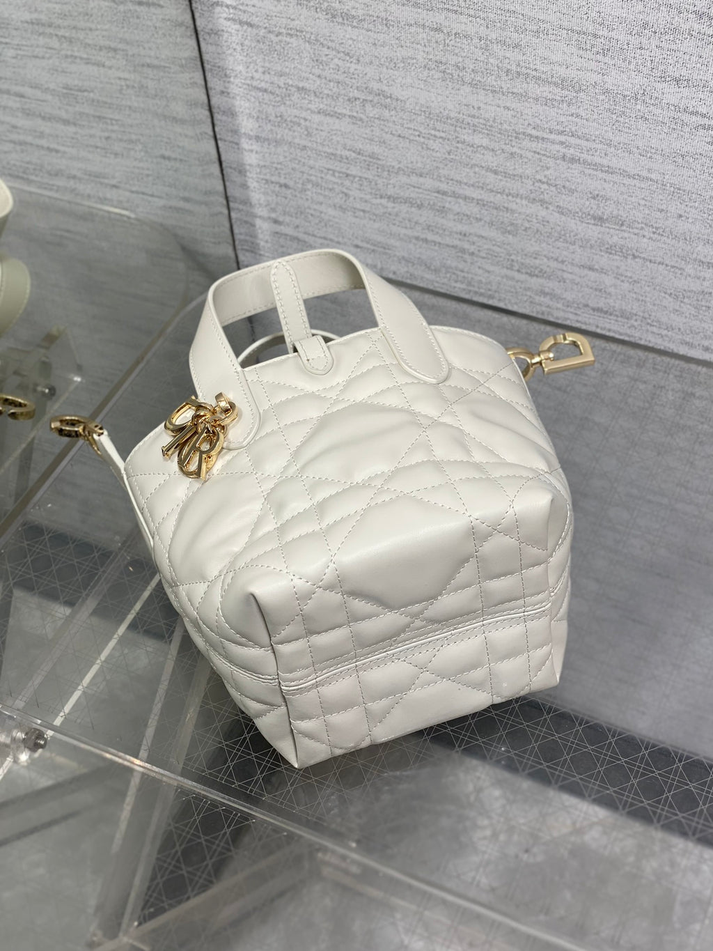 Dior quilted mini tote bag with top handle, white leather, gold charm detail