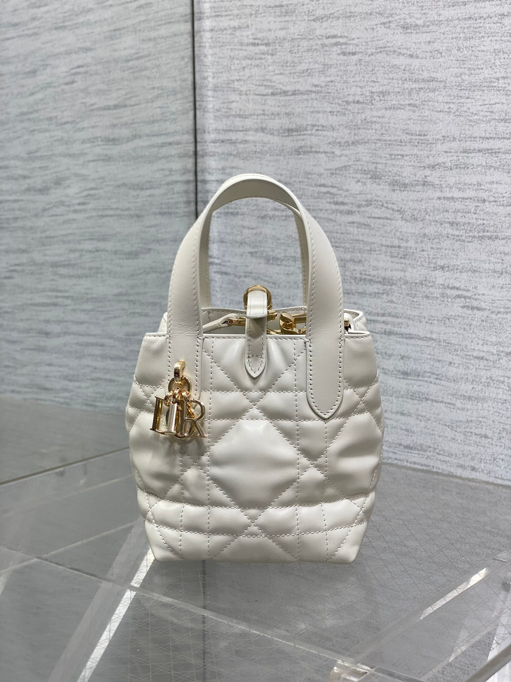 Dior quilted mini tote bag with front emblem, top handle, white leather, gold hardware