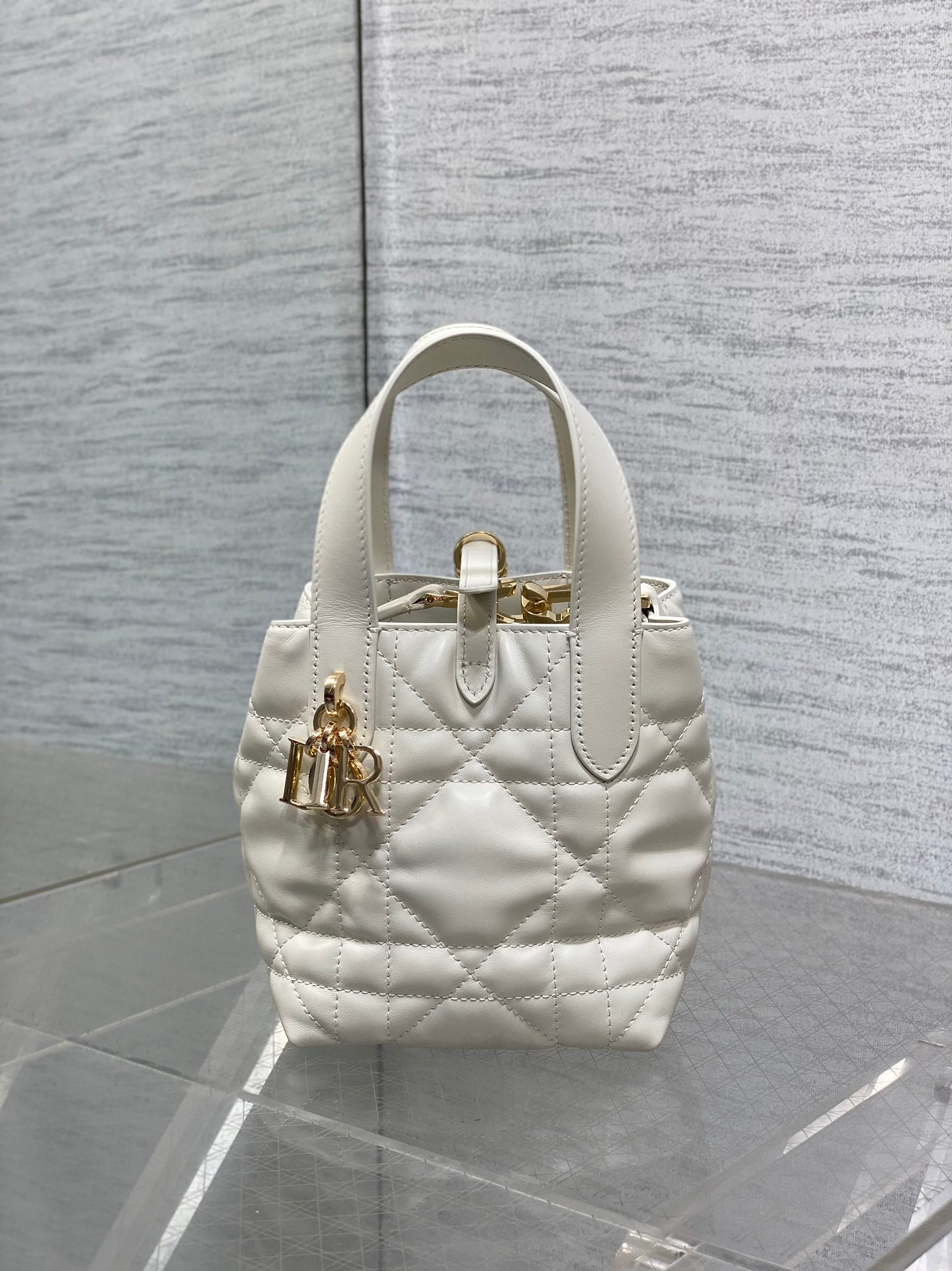 Dior quilted mini tote bag with front emblem, top handle, white leather, gold hardware