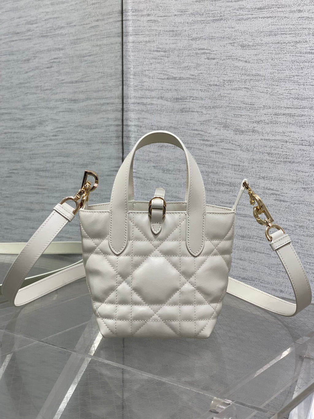 Dior quilted tote bag with dual straps, front buckle, white leather, gold hardware