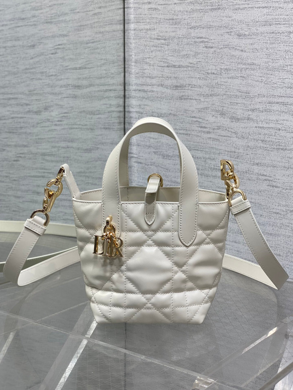 Dior quilted tote bag with top handle and shoulder strap, gold hardware, white leather