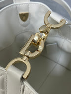 Dior bag interior with gold clasp and white leather lining