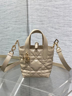 Dior quilted mini handbag with shoulder strap, gold hardware, and front charm