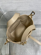 Dior mini handbag open interior with cream lining and side strap hardware