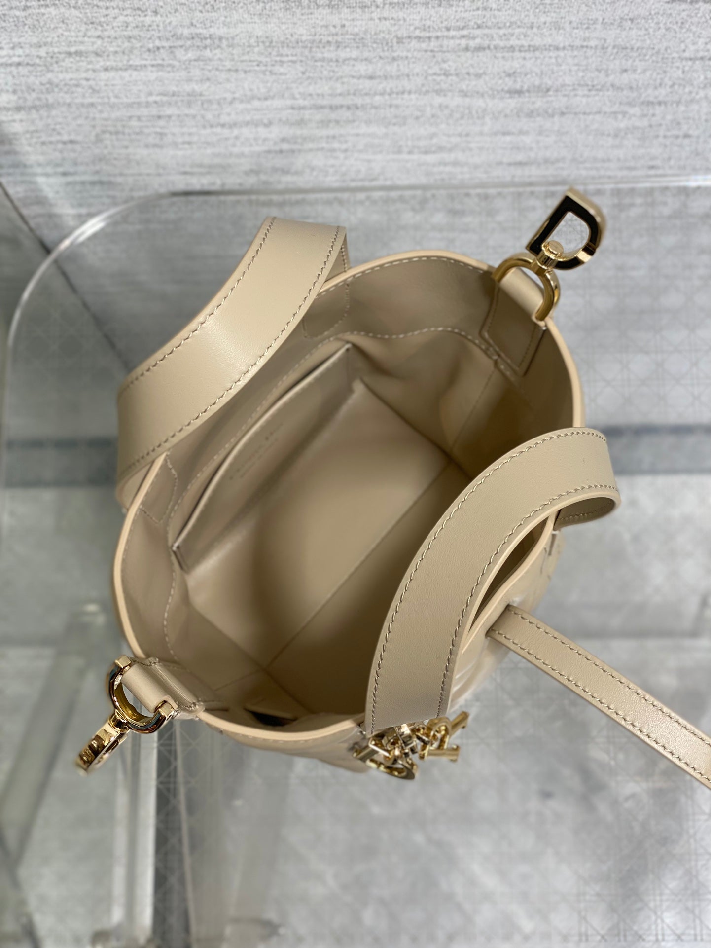 Dior mini handbag open interior with cream lining and side strap hardware