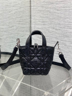 Black quilted mini handbag with top handle and crossbody straps