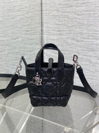 Black quilted mini handbag with two shoulder straps and front clasp