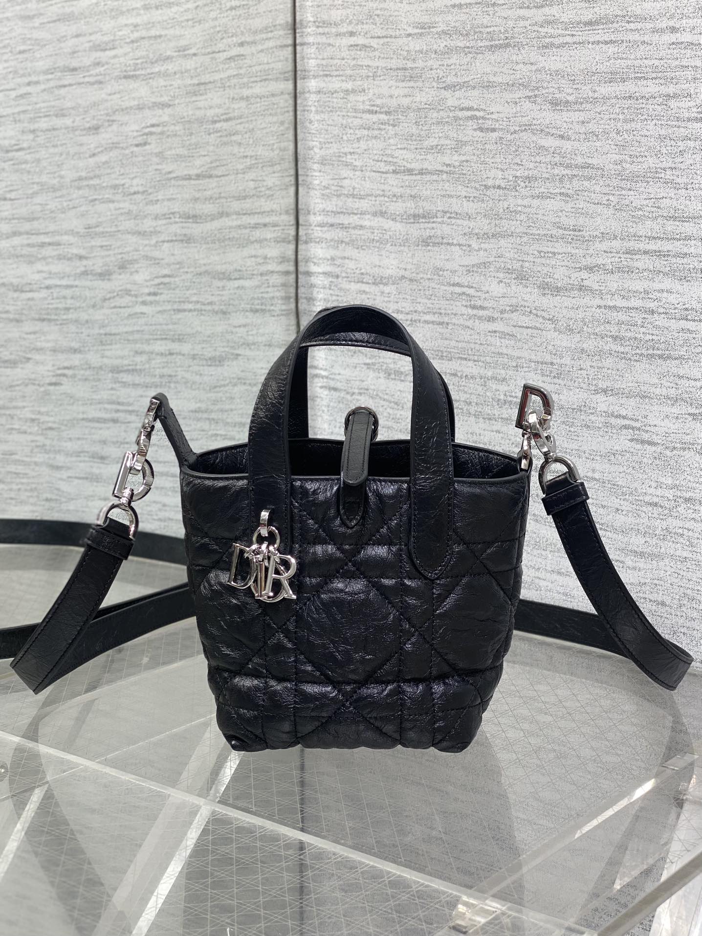 Black quilted mini handbag with two shoulder straps and front clasp
