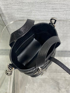 Black quilted mini handbag interior with structured lining and strap attachment