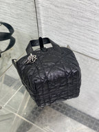 Black quilted mini handbag open top showing interior and shoulder strap