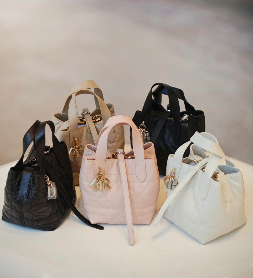 Dior bag set of quilted mini totes with top handles, straps, and dangling charms