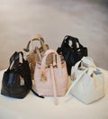 Dior bag set of quilted mini totes with top handles, straps, and dangling charms