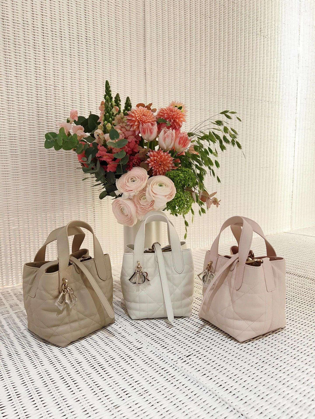 Dior bag trio of light beige mini totes with top handles and hanging charm accessory
