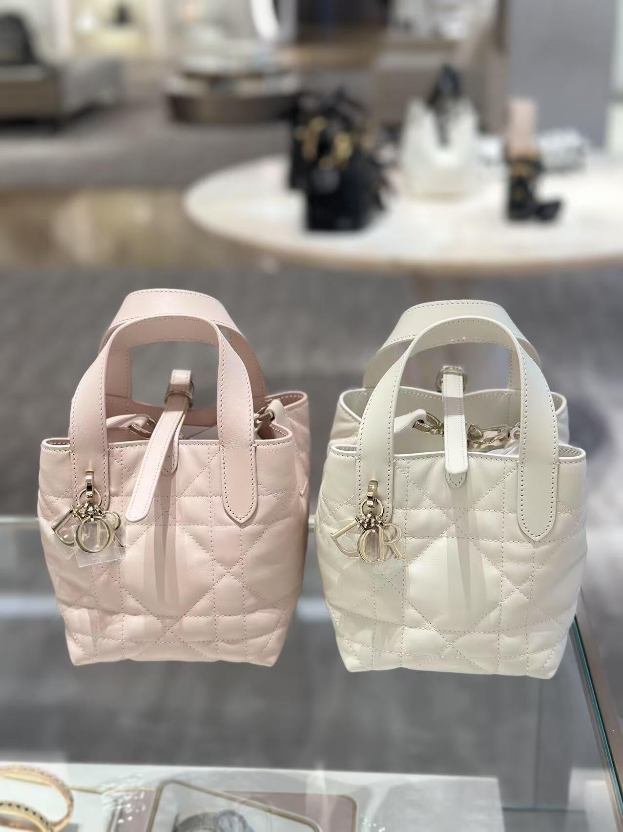 Dior bag pair of quilted mini totes in blush pink and white with logo charm and handles