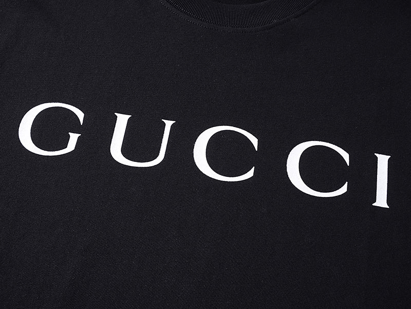 Black T-shirt with large white GUCCI lettering