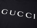 Black T-shirt with large white GUCCI lettering