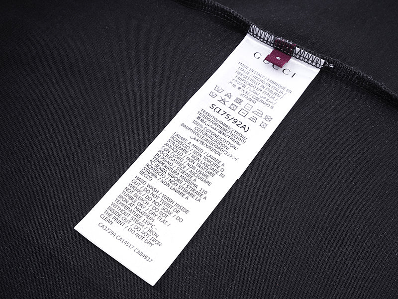 Black T-shirt with white size label near inner neck