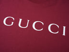 Burgundy Gucci T-shirt front with partial white GUCCI lettering
