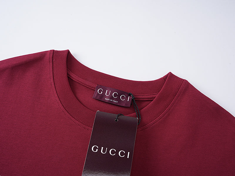 Burgundy Gucci T-shirt neckline with GUCCI logo patch tag