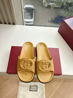 Gold Gucci slide sandals pair view with interlocking G logo; dust bag