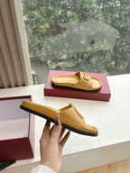 Gold Gucci slide sandals, side view with interlocking G emblem