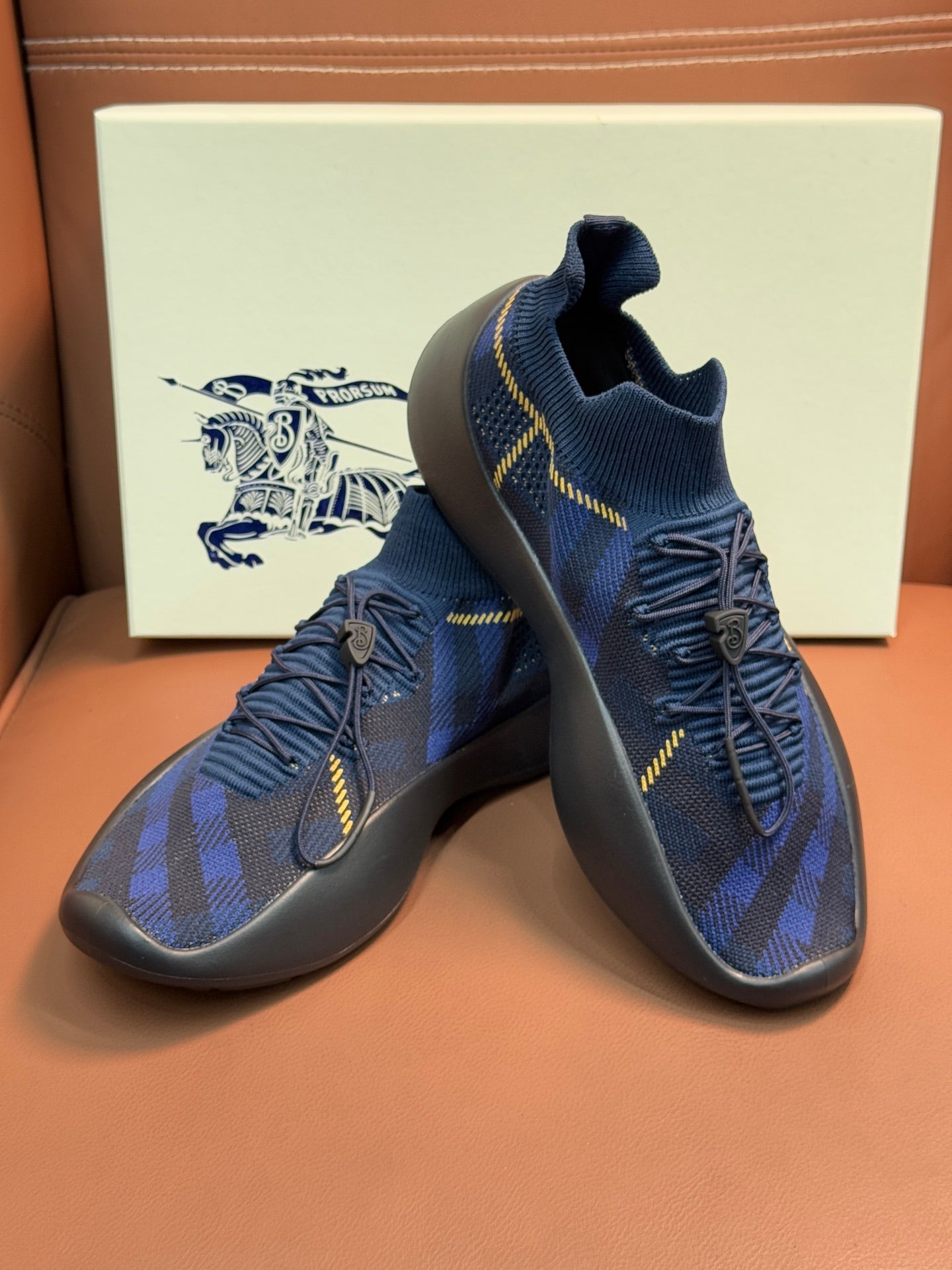 Burberry blue knit sneakers pair with yellow trim and lace-up upper