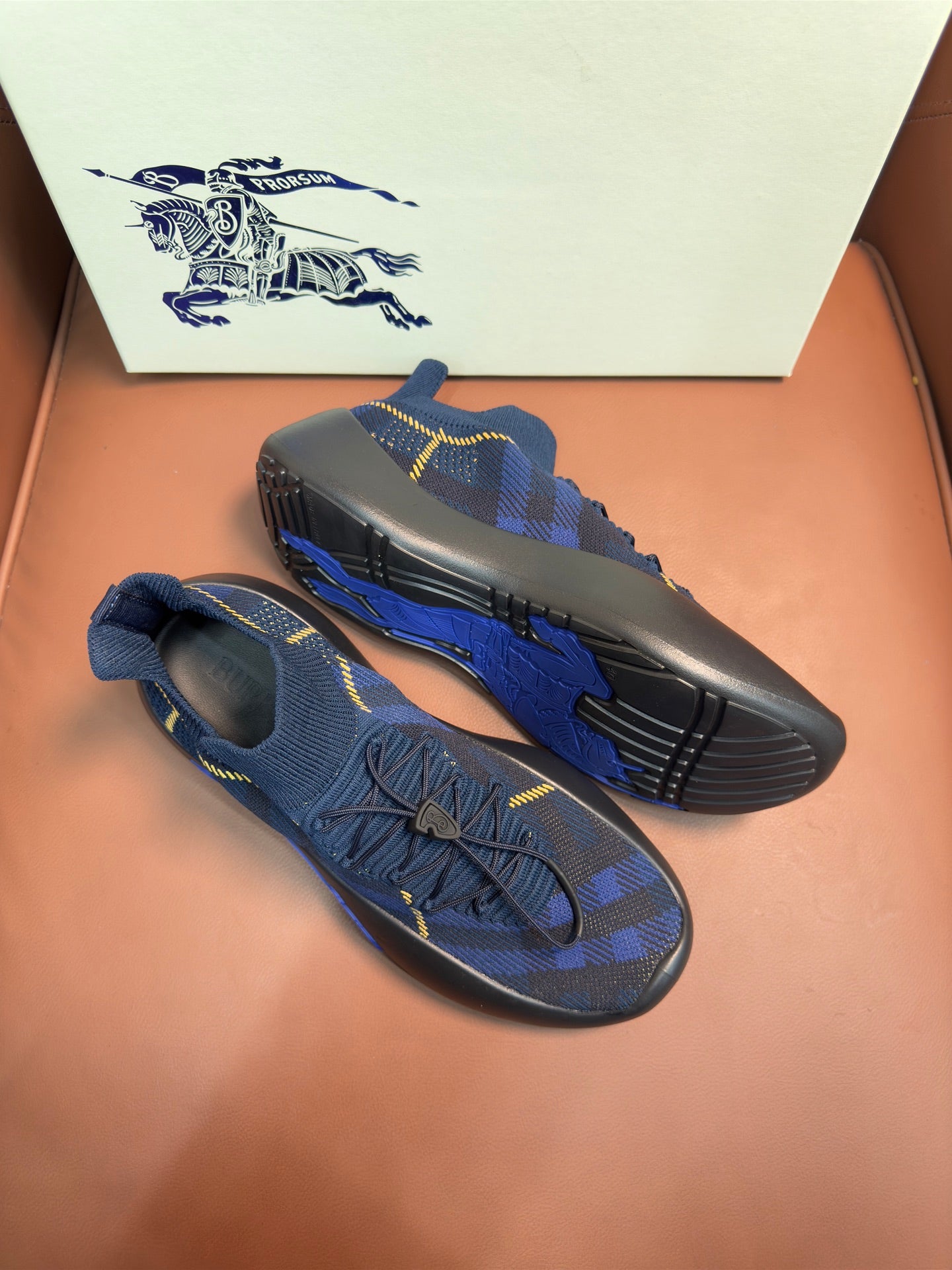 Burberry blue knit sneakers with textured sole and yellow stripe detail