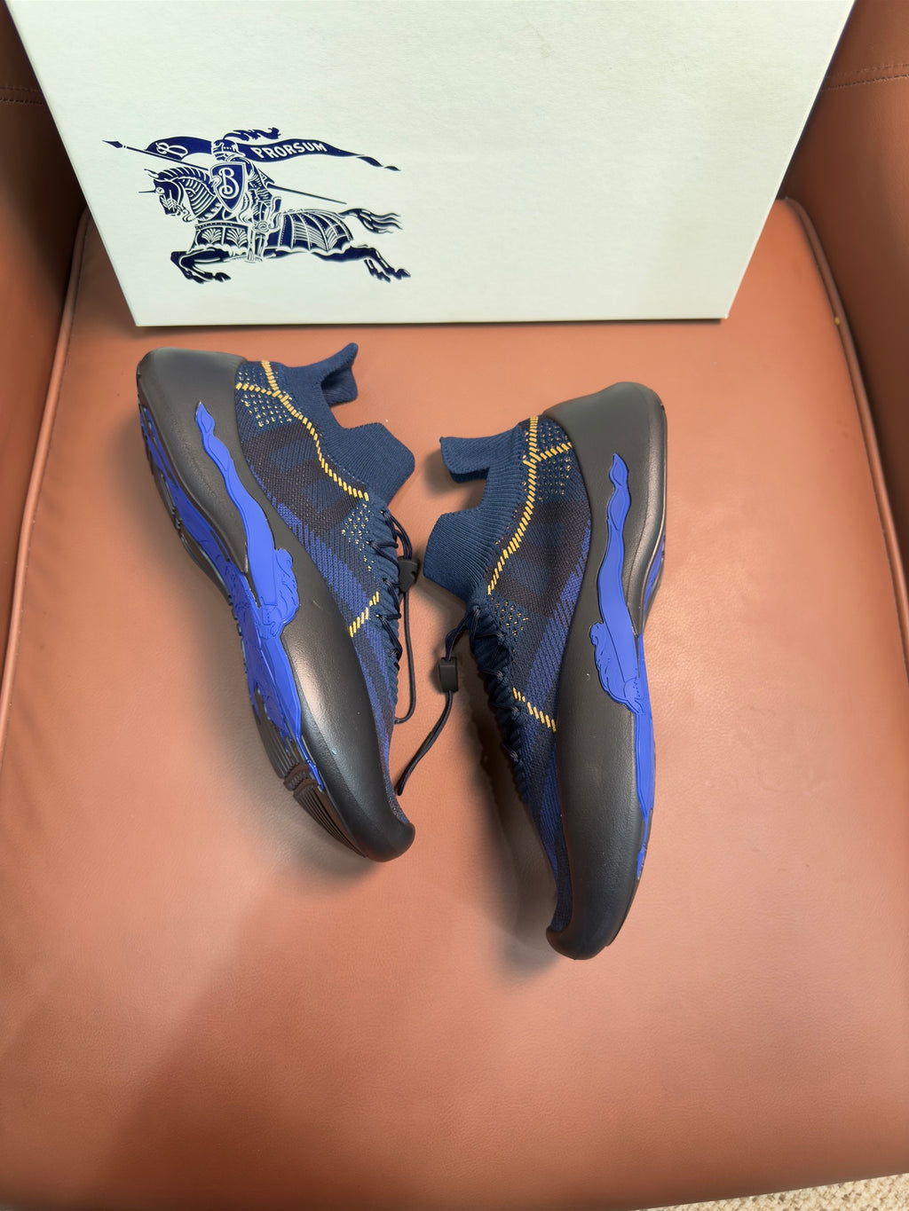 Burberry blue knit sneakers with yellow stitching and lace-up front