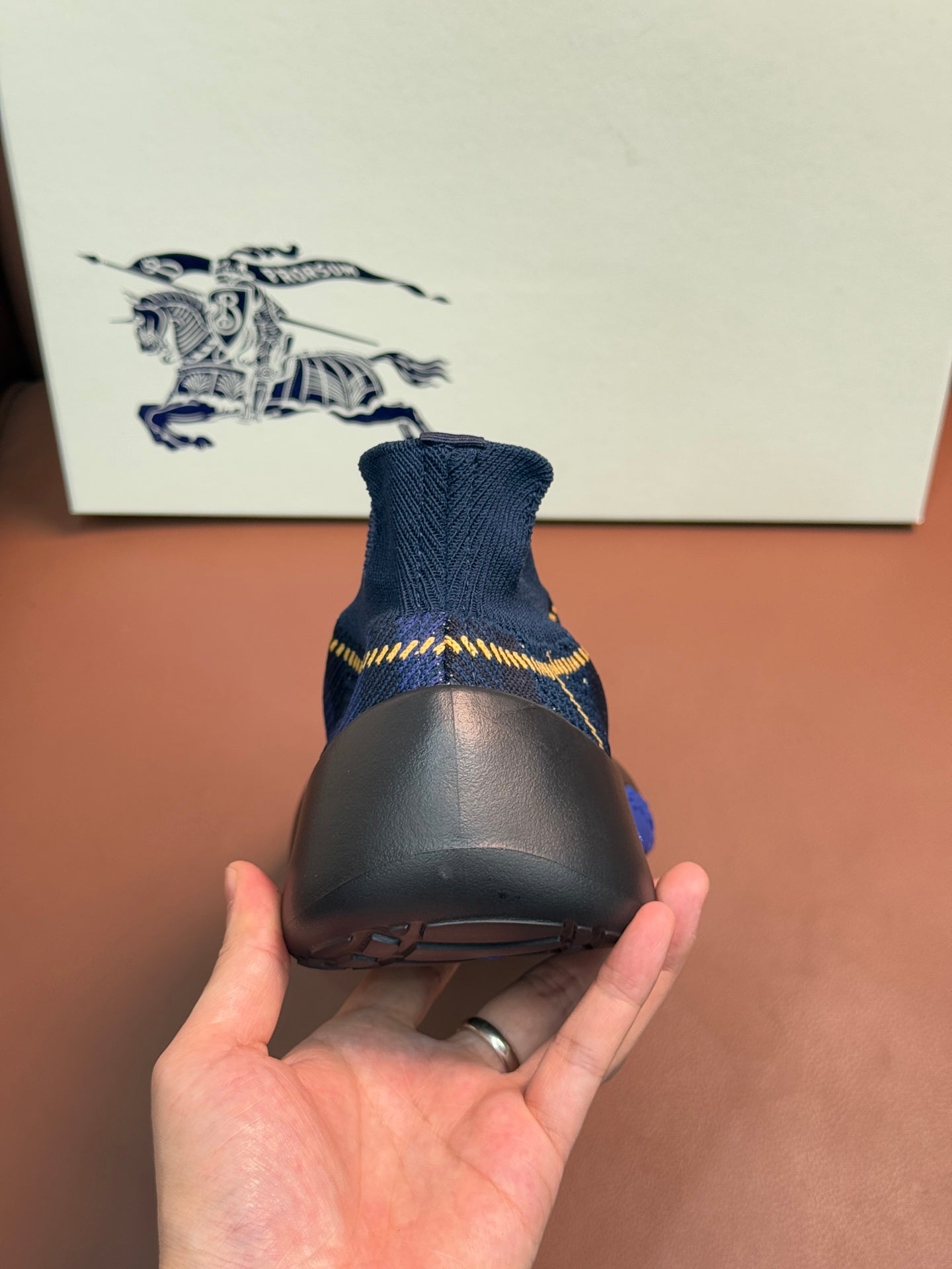 Burberry blue knit sneaker heel with black sole and yellow stripe detail